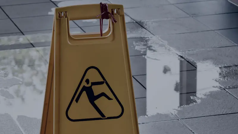 A caution wet floor sign on a wet tiled floor
